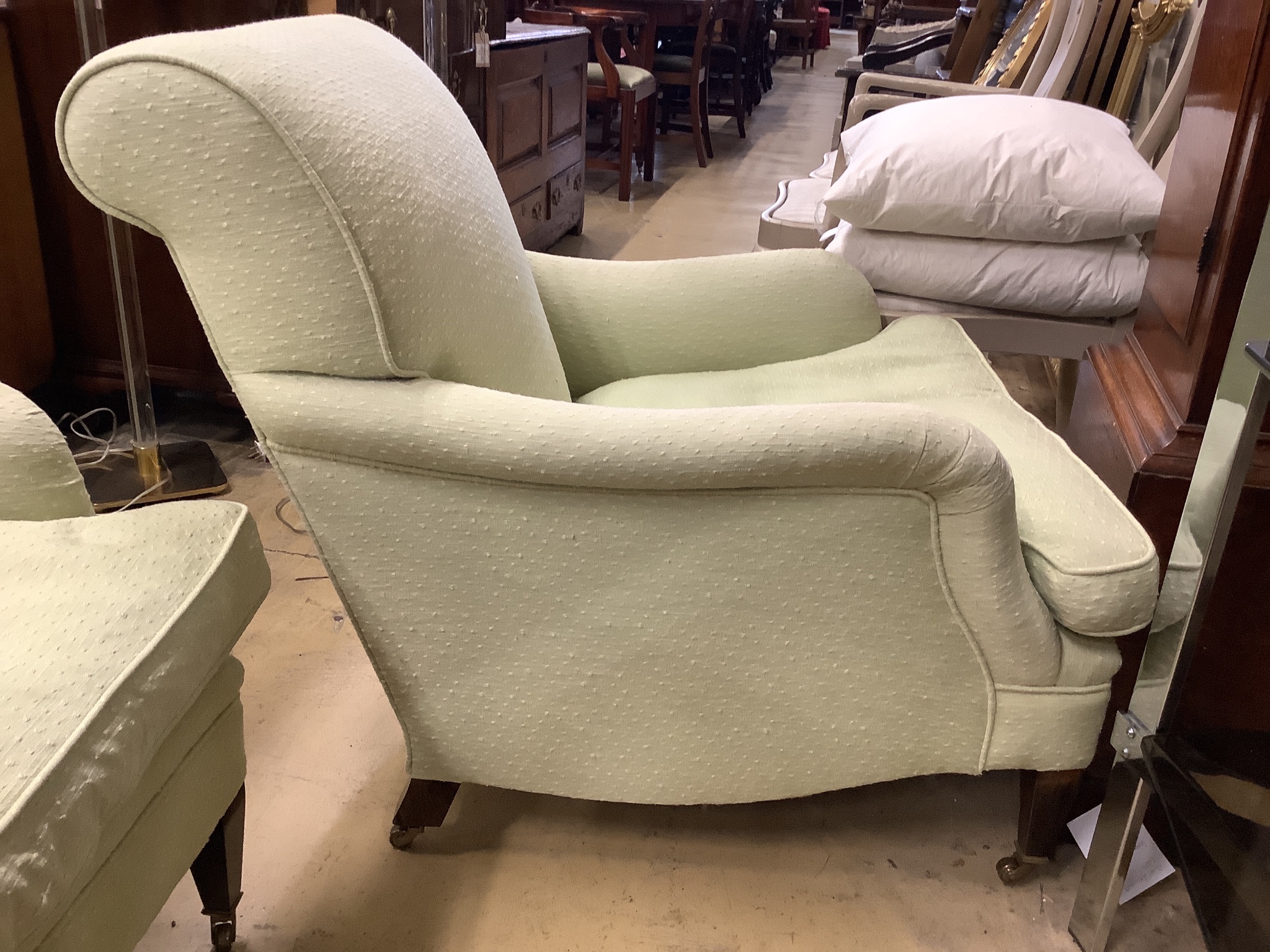 A pair of Howard style armchairs upholstered in lime green fabric. W-70, D-94, H-80cm.